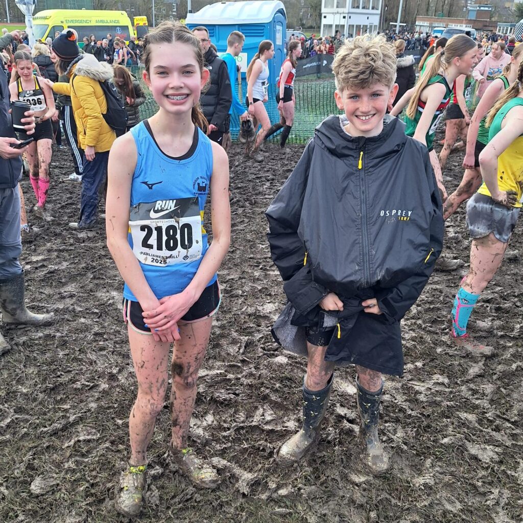 Roxy Heffer and Mark Bourne still smiling after fighting their way through the mud to finish their National Cross Country races at Parliament Hill!